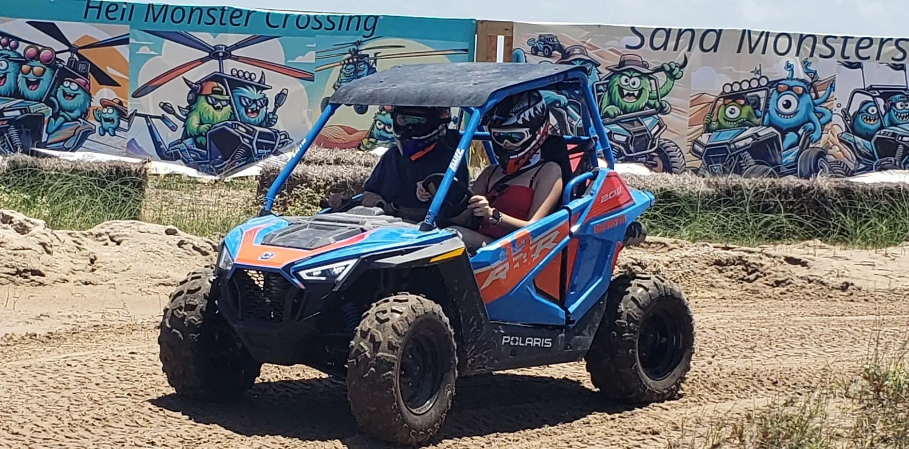 A man riding an atv on top of dirt.