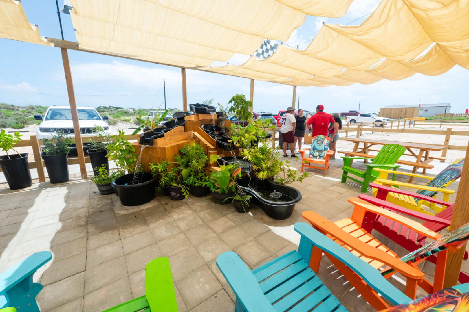 A large patio with several colorful chairs and tables.