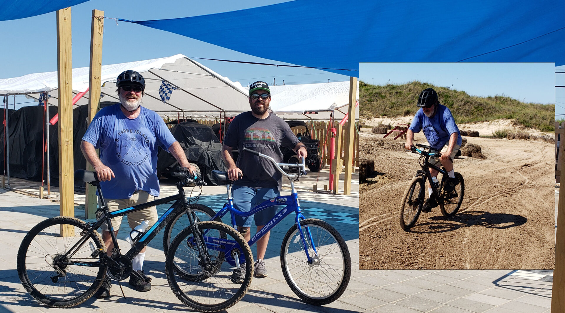 Two men with bikes in a dirt field.